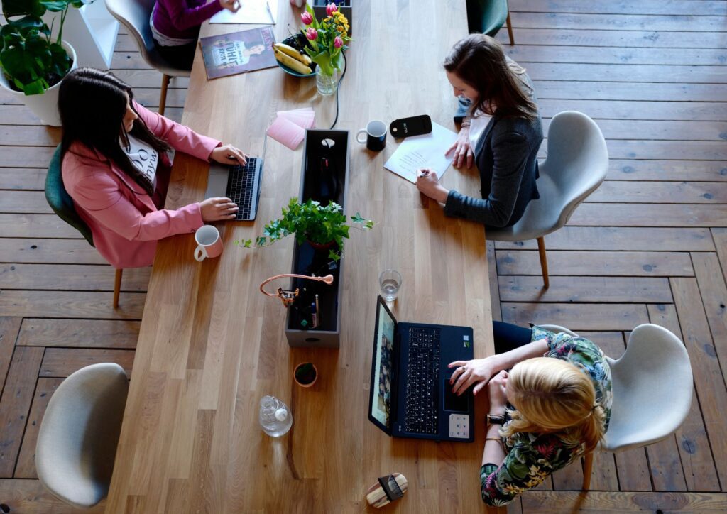 Professionisti al lavoro in uno spazio coworking con laptop e documenti